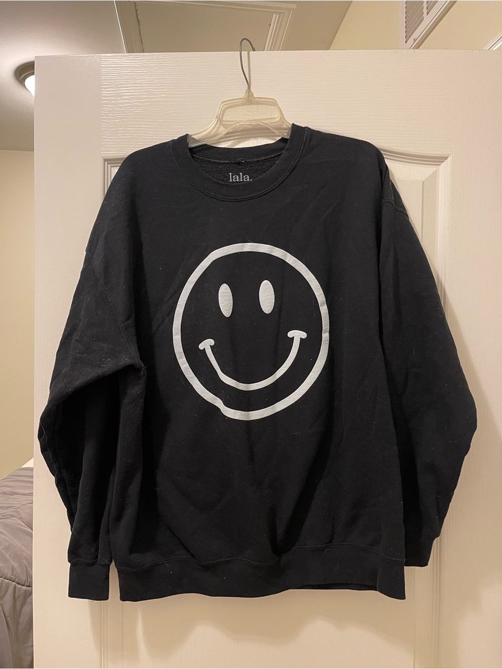 Dressed in LALA Black Crewneck Sweater with White Smiley Graphic